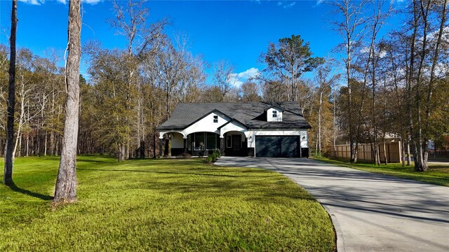 view of front facade featuring a garage and a front lawn