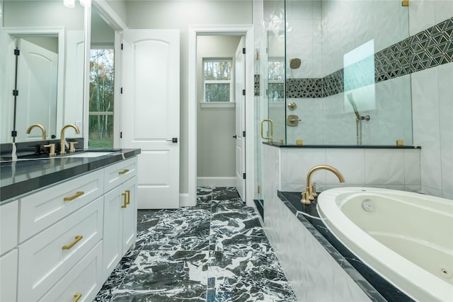 bathroom featuring vanity and shower with separate bathtub