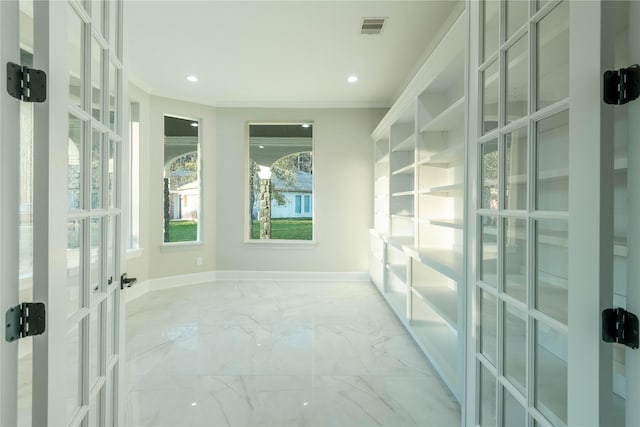 interior space with crown molding and french doors