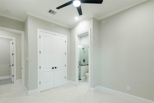 unfurnished bedroom with crown molding, connected bathroom, ceiling fan, and a closet