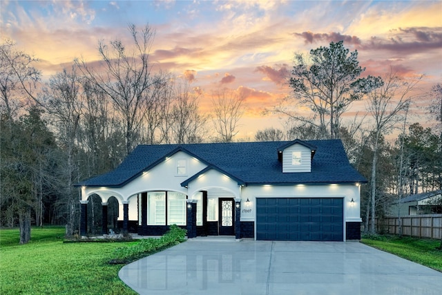 view of front facade featuring a garage and a lawn