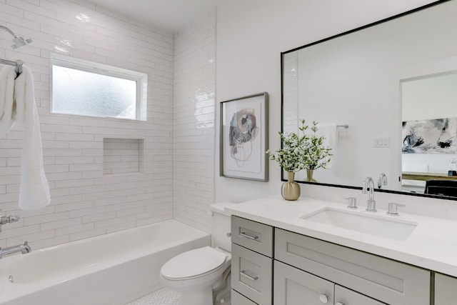 full bathroom with tiled shower / bath, vanity, and toilet