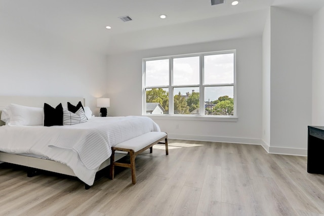 bedroom with multiple windows and light wood-type flooring