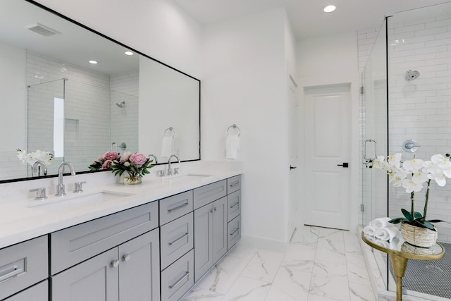 bathroom with a shower with door and vanity