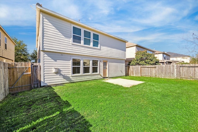 back of property with a lawn and a patio