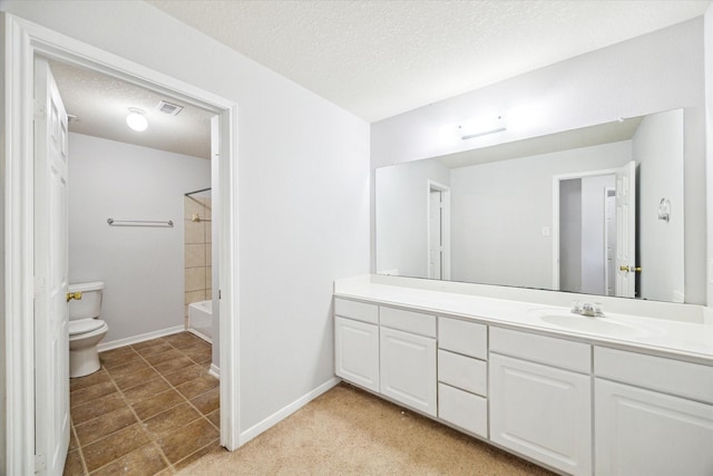 full bathroom featuring vanity, a textured ceiling, and toilet