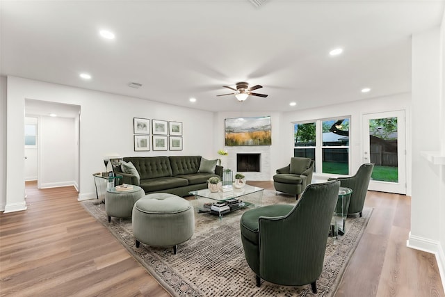 living room with ceiling fan and light hardwood / wood-style floors