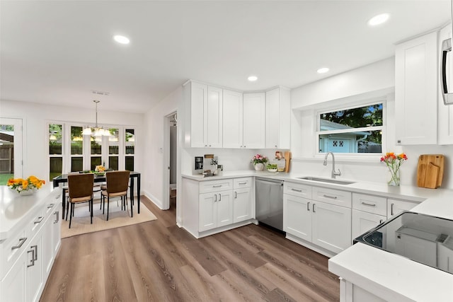 kitchen featuring white cabinetry, appliances with stainless steel finishes, dark wood-type flooring, and sink