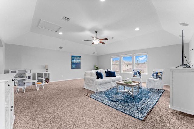 carpeted living room featuring ceiling fan and a tray ceiling