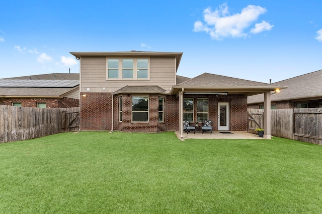 rear view of house with a patio area and a lawn