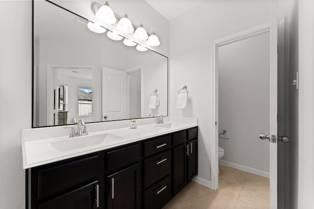 bathroom featuring vanity, toilet, and tile patterned flooring