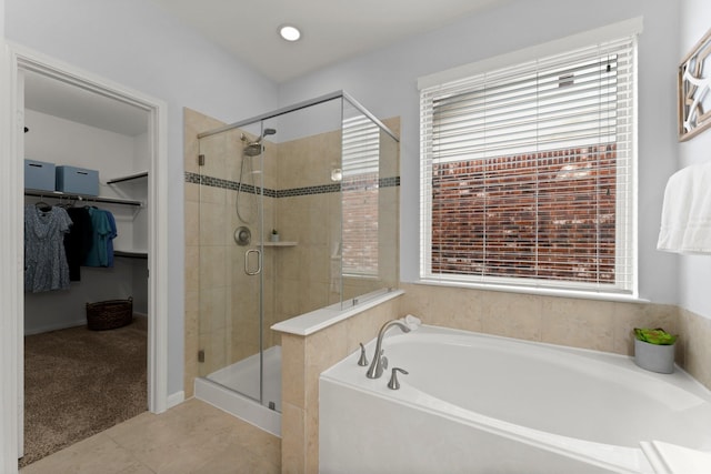 bathroom featuring tile patterned floors, shower with separate bathtub, and a wealth of natural light