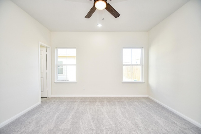 unfurnished room with light colored carpet and ceiling fan