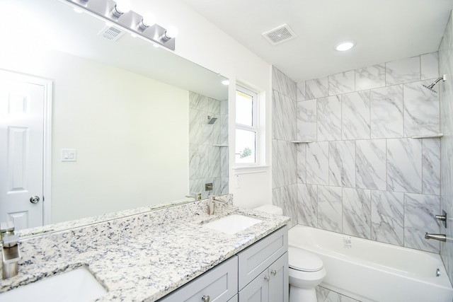 full bathroom with vanity, toilet, and tiled shower / bath