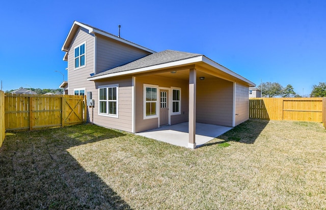 back of property with a yard and a patio area