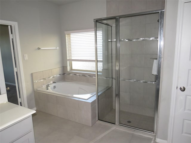 bathroom with vanity, tile patterned floors, and shower with separate bathtub