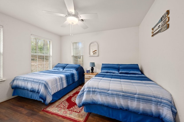 bedroom with dark wood-type flooring and ceiling fan