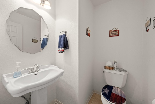 bathroom with sink, tile patterned floors, and toilet