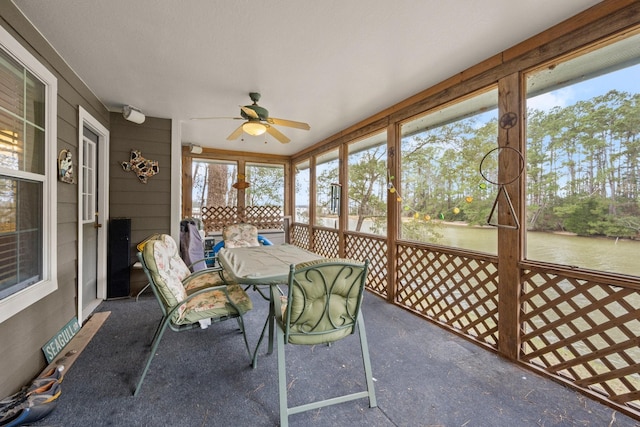 unfurnished sunroom with ceiling fan