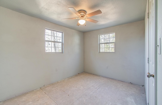 spare room with a wealth of natural light and ceiling fan