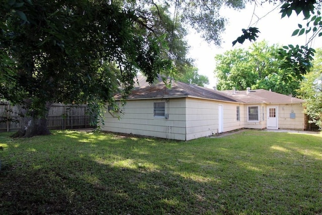 back of house with a lawn