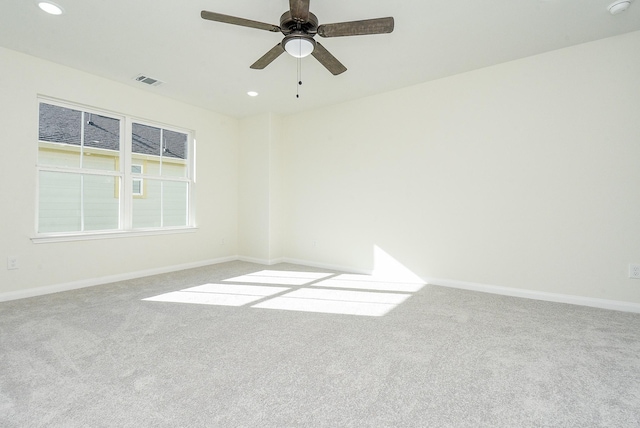 unfurnished room with light colored carpet and ceiling fan