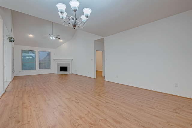 unfurnished living room featuring high vaulted ceiling, ceiling fan with notable chandelier, and light wood-type flooring