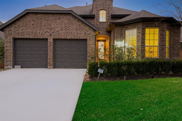 view of front of property with a garage and a front yard