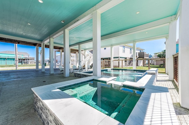 view of pool featuring an in ground hot tub