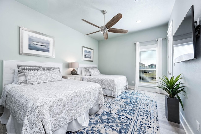 bedroom with light hardwood / wood-style flooring and ceiling fan