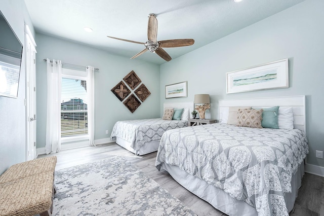 bedroom with light hardwood / wood-style flooring and ceiling fan