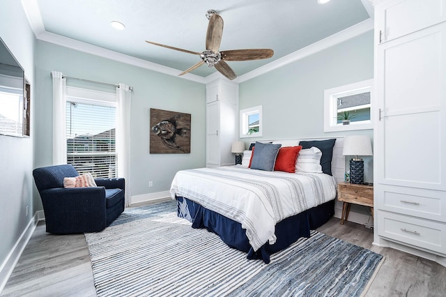 bedroom featuring ceiling fan, ornamental molding, and light hardwood / wood-style flooring