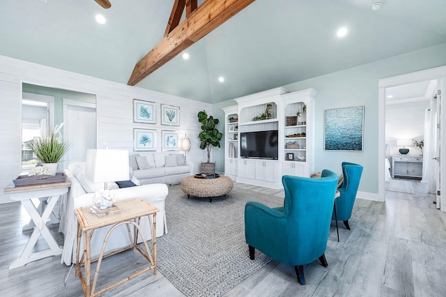 living room with lofted ceiling with beams and light hardwood / wood-style floors