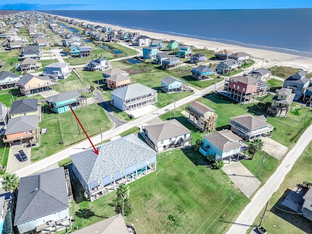 birds eye view of property with a view of the beach and a water view