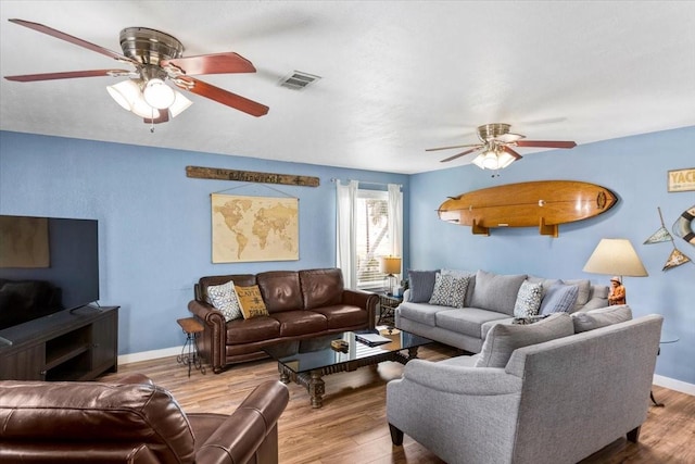 living room with hardwood / wood-style flooring and ceiling fan