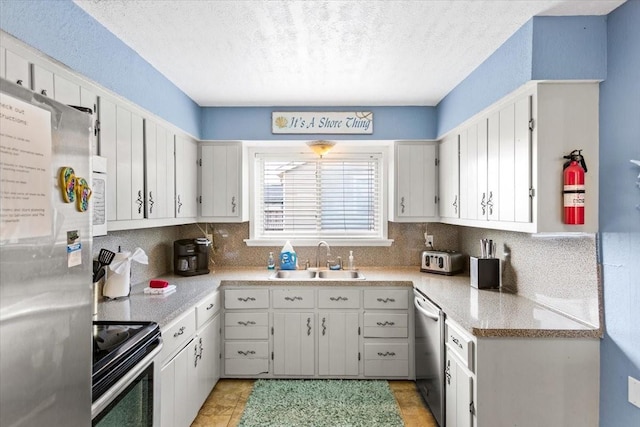 kitchen with sink, stainless steel appliances, and white cabinets