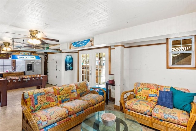 living room featuring french doors and ceiling fan