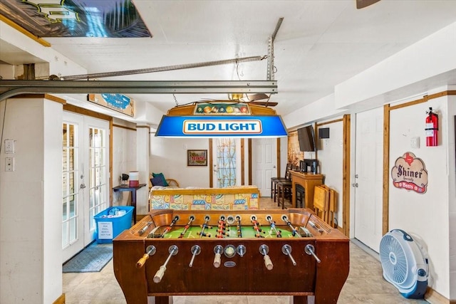 rec room with concrete flooring and french doors