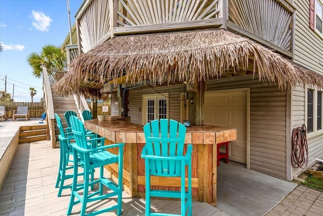 view of patio featuring a wooden deck and exterior bar