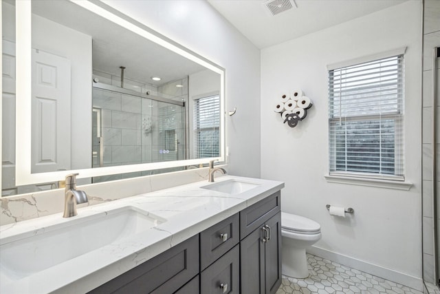 bathroom with vanity, an enclosed shower, tile patterned floors, and toilet