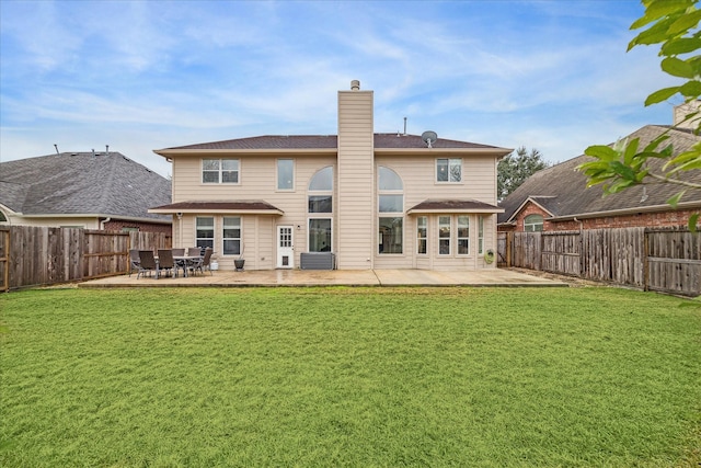 back of house with a yard and a patio area