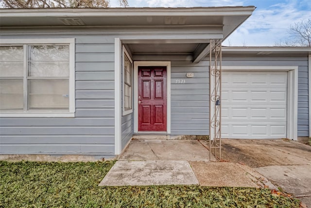 view of exterior entry with a garage