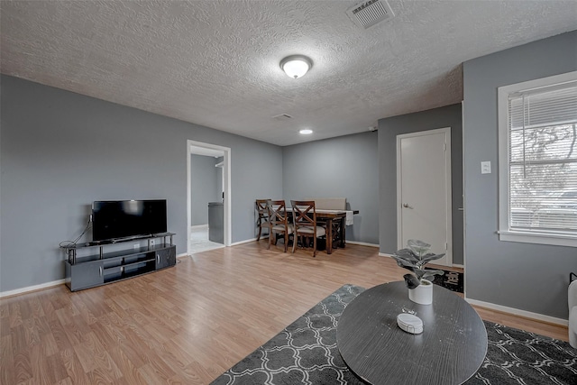 living room with hardwood / wood-style flooring and a textured ceiling