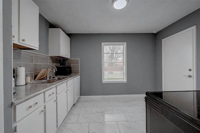 kitchen featuring sink, dishwasher, tasteful backsplash, a textured ceiling, and white cabinets