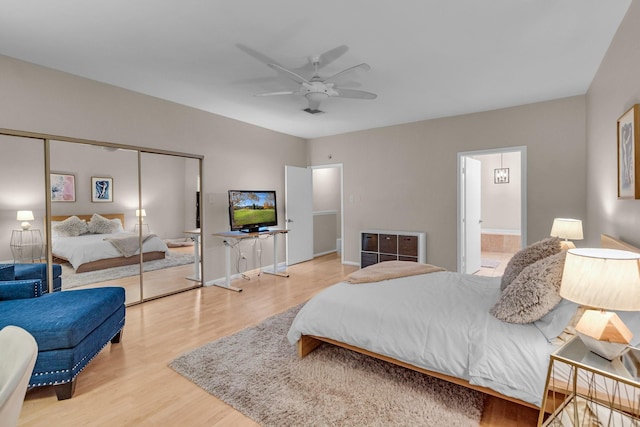 bedroom featuring hardwood / wood-style flooring, ceiling fan, ensuite bath, and a closet