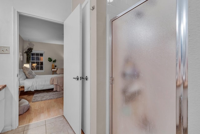 bathroom featuring tile patterned flooring and a shower with door