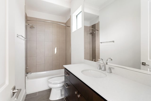 full bathroom with tiled shower / bath, vanity, tile patterned floors, and toilet