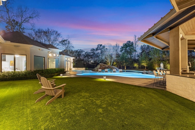 yard at dusk with a patio area