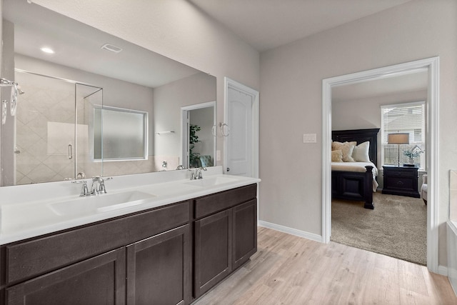 bathroom with vanity, hardwood / wood-style floors, and an enclosed shower