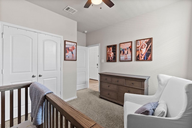 carpeted bedroom with ceiling fan and a closet